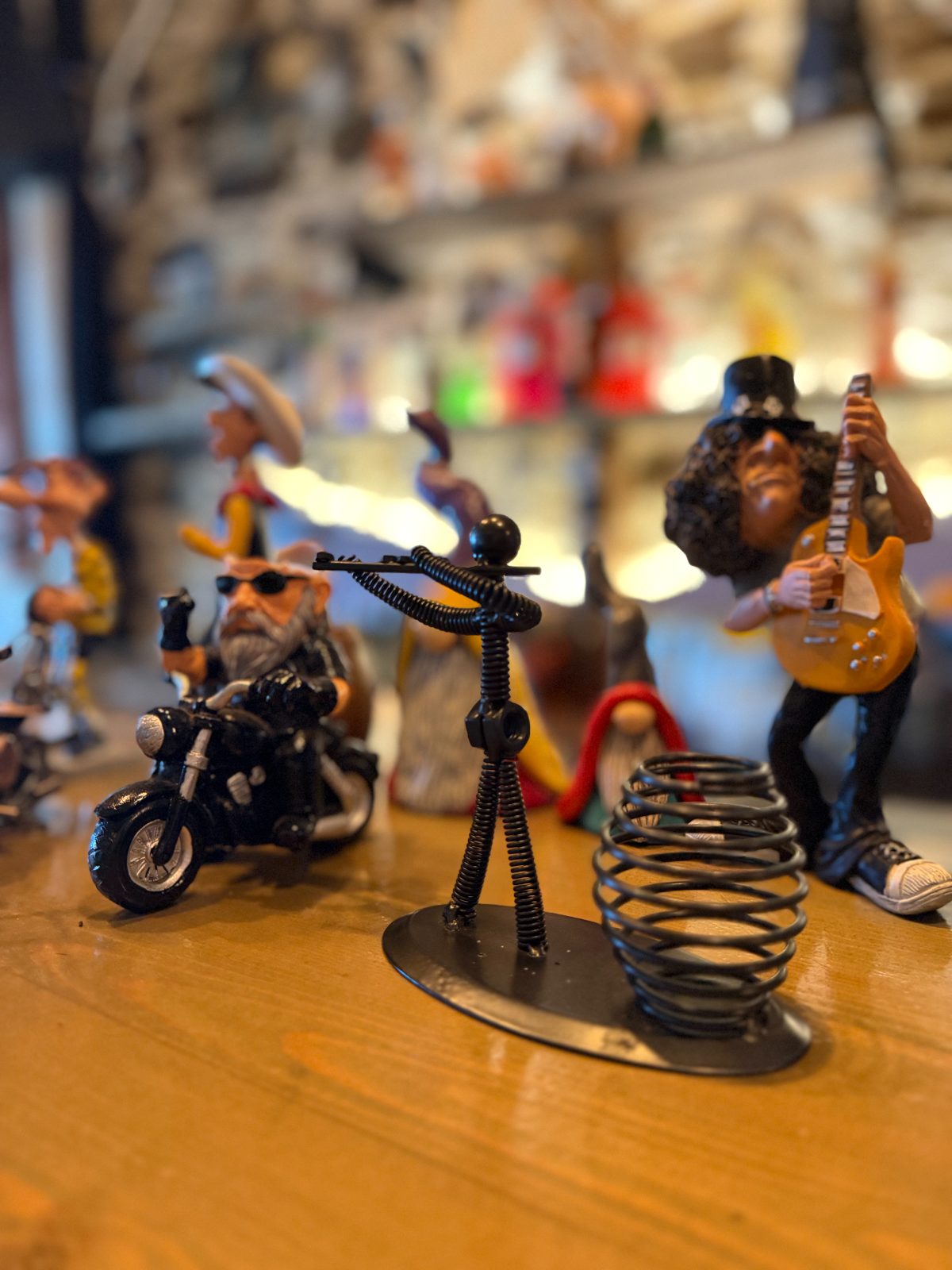 Rock star figurine collection on the bar shelf, guitarist front and centre